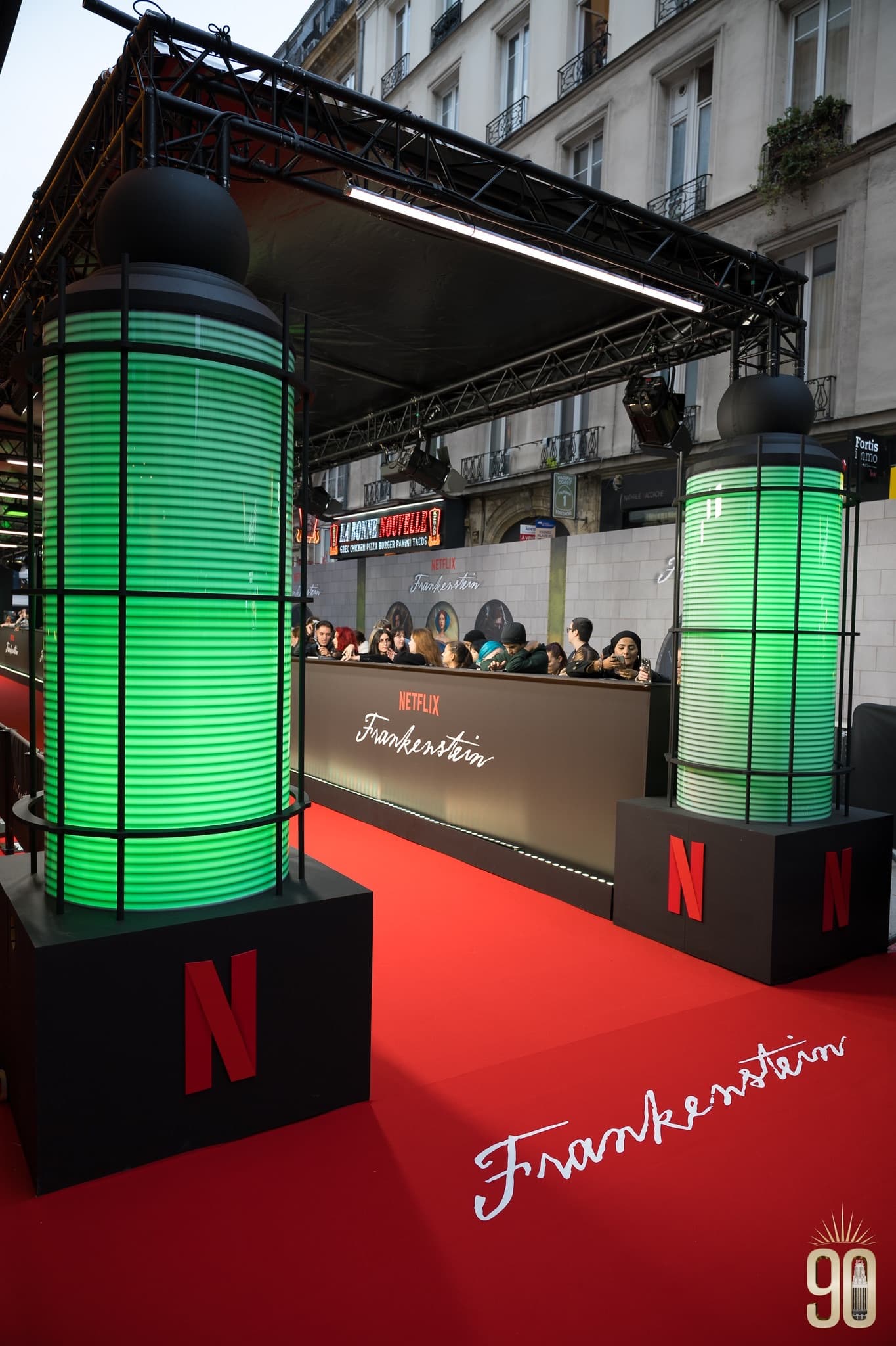 Arrivals set-up on the pavement outside the Grand Rex: red carpet, green lighting towers and control booth