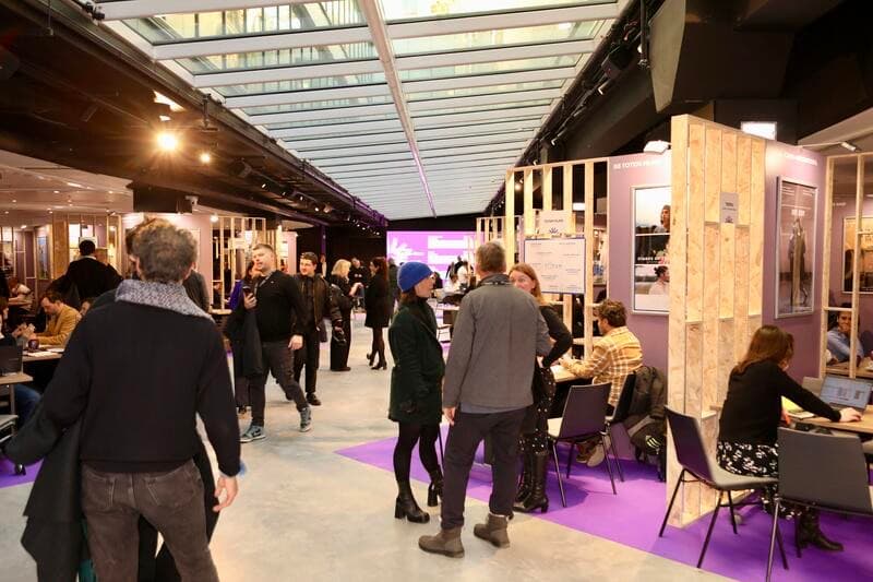 Aisle of a Unifrance industry space, meeting booths and work tables